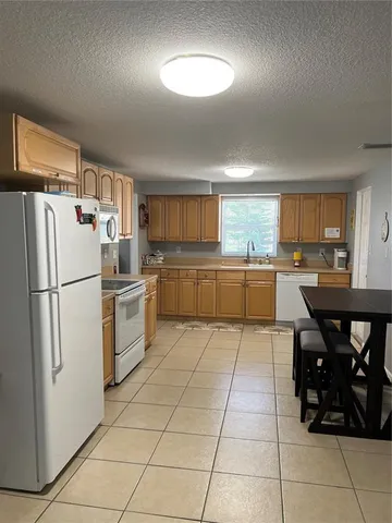 a kitchen with stainless steel appliances a refrigerator sink and cabinets