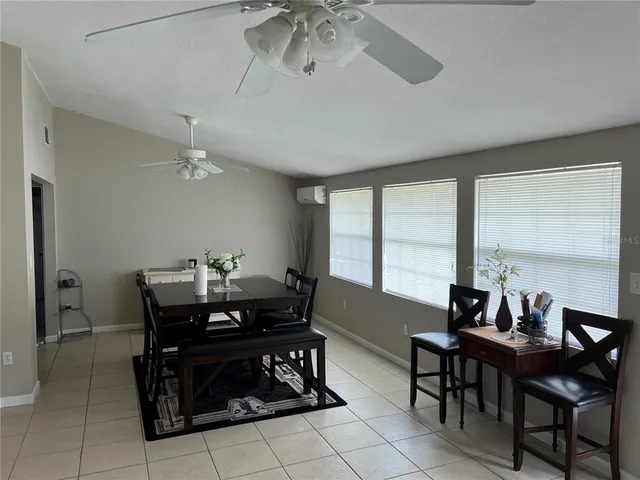 a view of a dining room with furniture and window