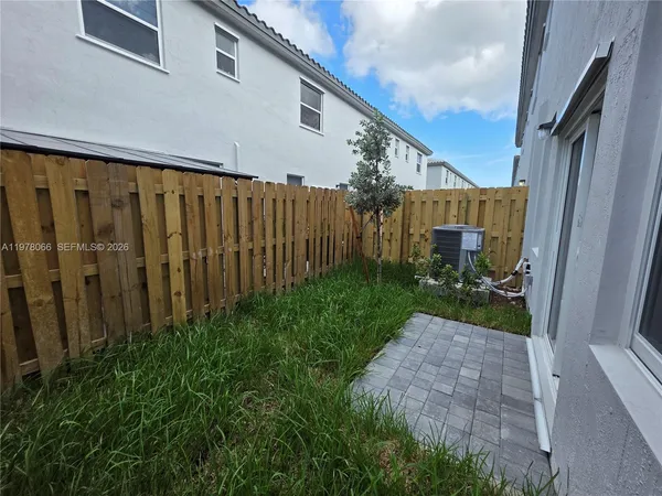 a view of a backyard with pathway