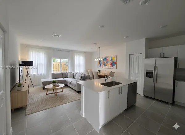 a kitchen with refrigerator and window