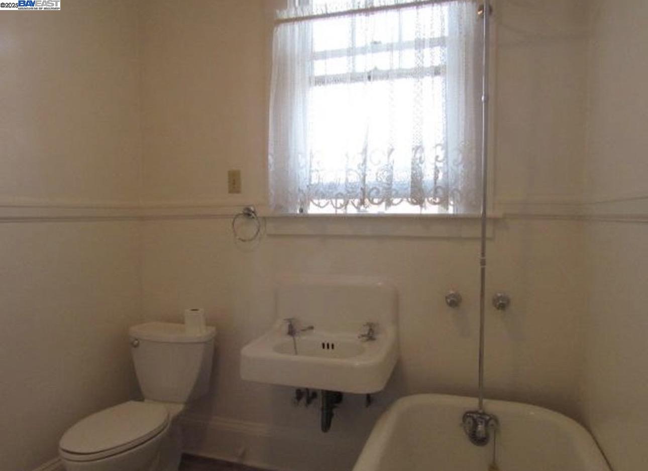1606 Morton Street Alameda, CA 94501 - Photo 18 of 48 a bathroom with a toilet sink and window