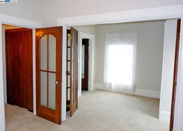 an empty room with wooden floor and a window