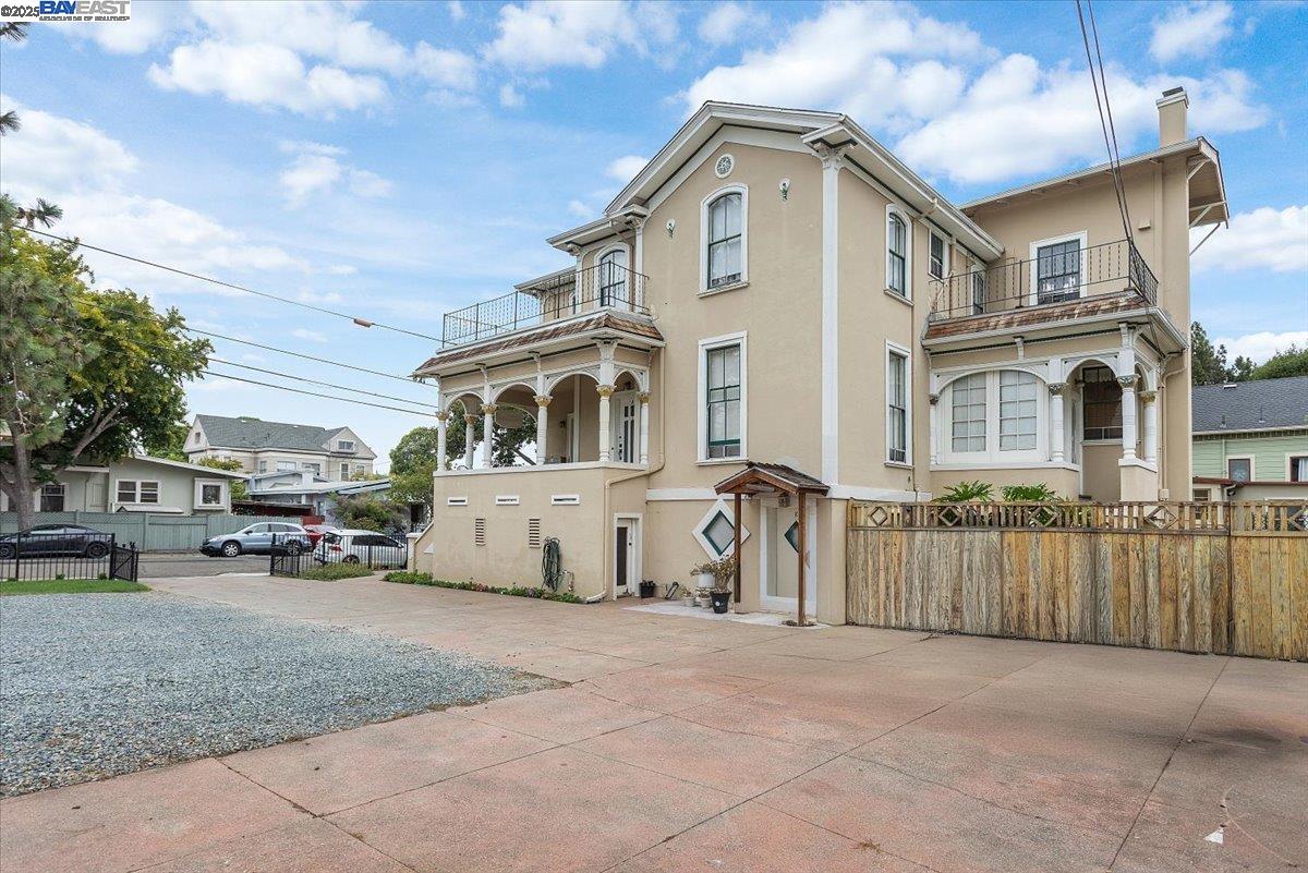 1606 Morton Street Alameda, CA 94501 - Photo 22 of 48 a view of a white house with large trees and outdoor space