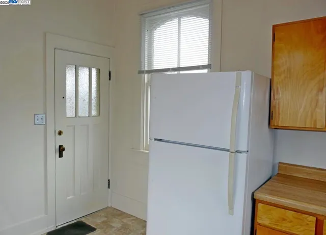 a white refrigerator freezer and a window