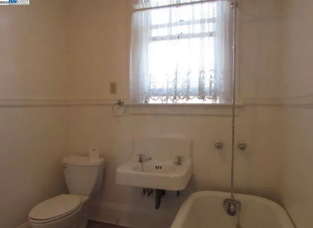 a bathroom with a toilet sink and window