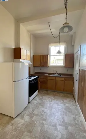 a kitchen with a refrigerator and a sink