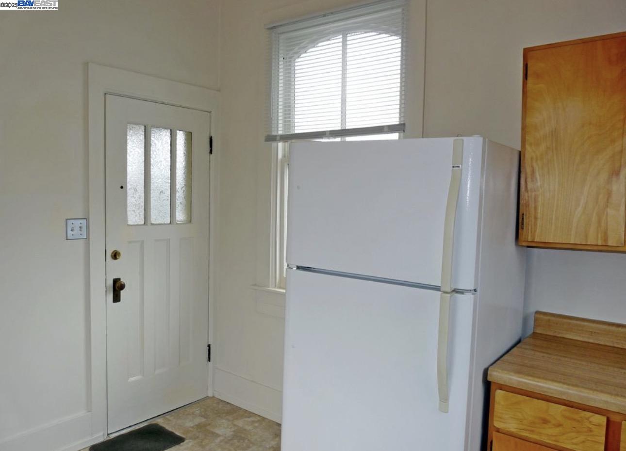 1606 Morton Street Alameda, CA 94501 - Photo 5 of 48 a white refrigerator freezer and a window
