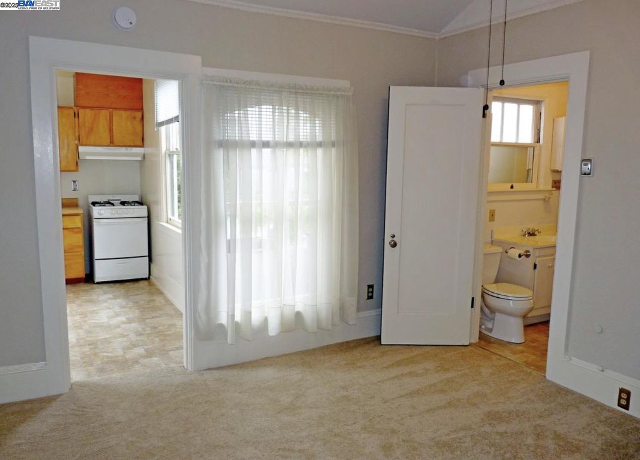 1606 Morton Street Alameda, CA 94501 - Photo 10 of 48 a view of an empty room with a fireplace and a window