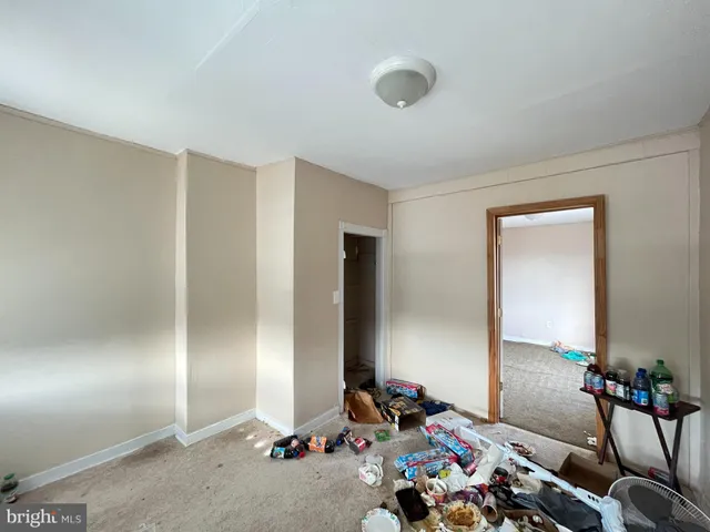a pathway of a house with a yard and sitting area