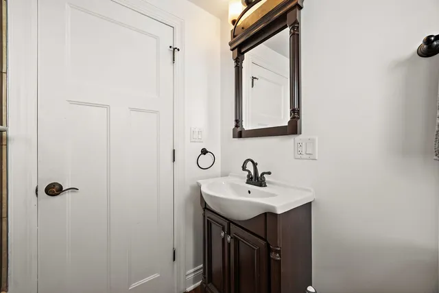 a bathroom with a sink a mirror and shower