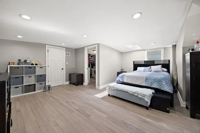 a spacious bedroom with a bed and closet