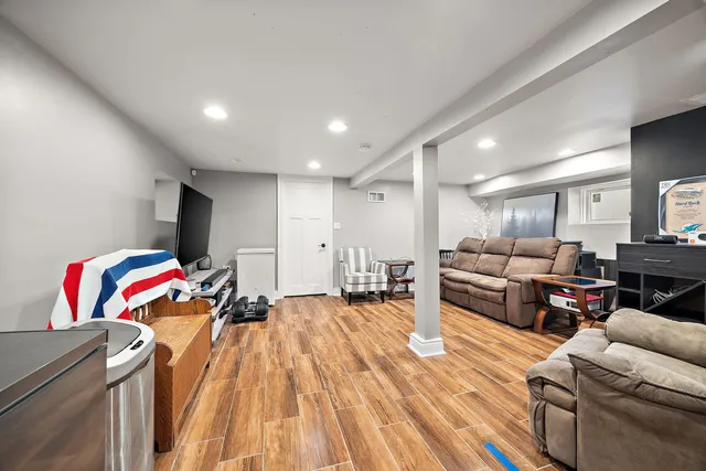 a living room with furniture and a wooden floor