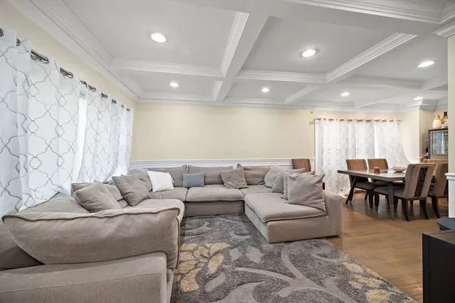 a living room with furniture and a dining table with kitchen view