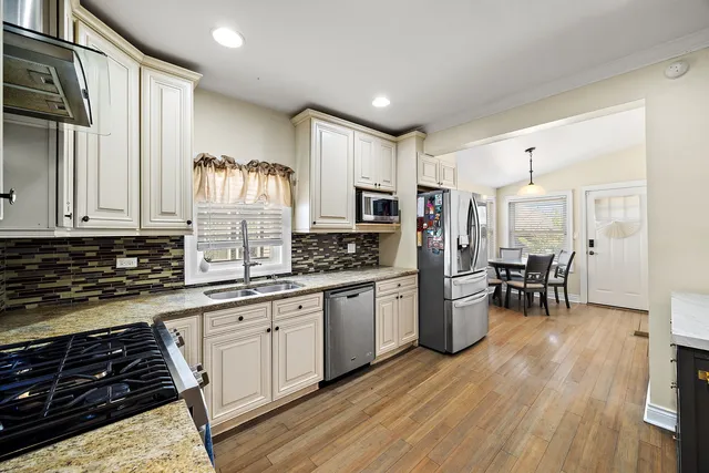 a kitchen with sink cabinets and wooden floor