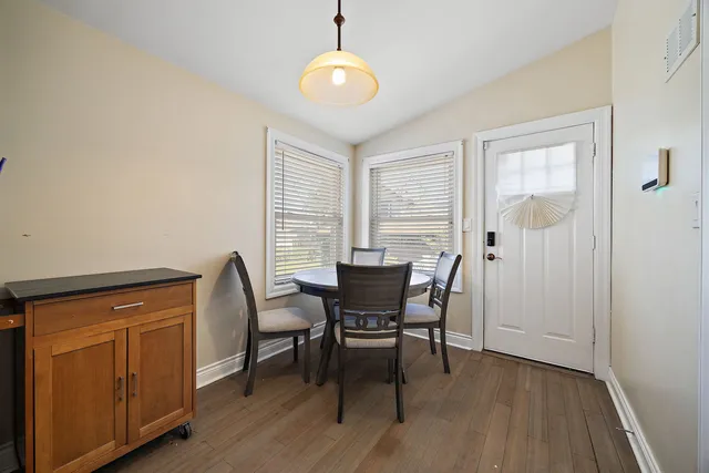 a view of a dining room with furniture window and wooden floor