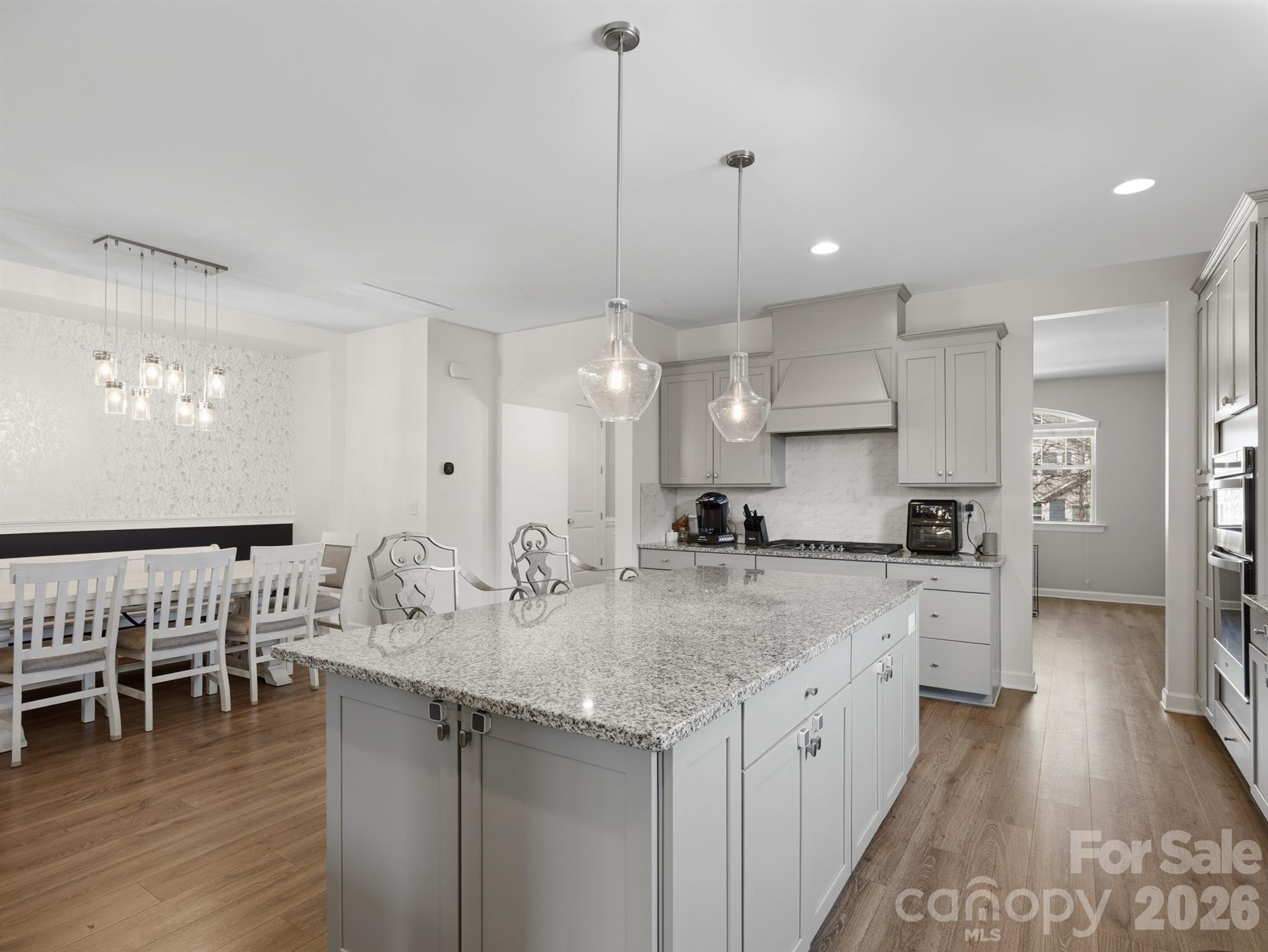 560 Sandbar Point Clover, SC 29710 - Photo 11 of 48 a kitchen with kitchen island a sink stove and wooden floor