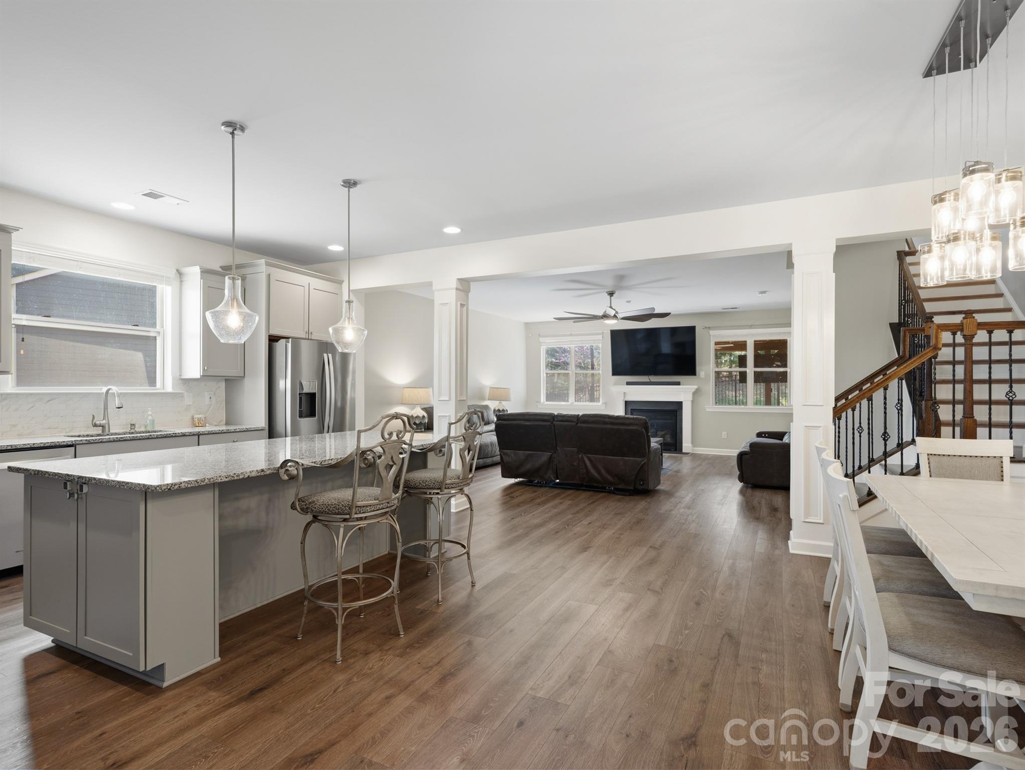 560 Sandbar Point Clover, SC 29710 - Photo 12 of 48 a kitchen with a table chairs refrigerator and cabinets