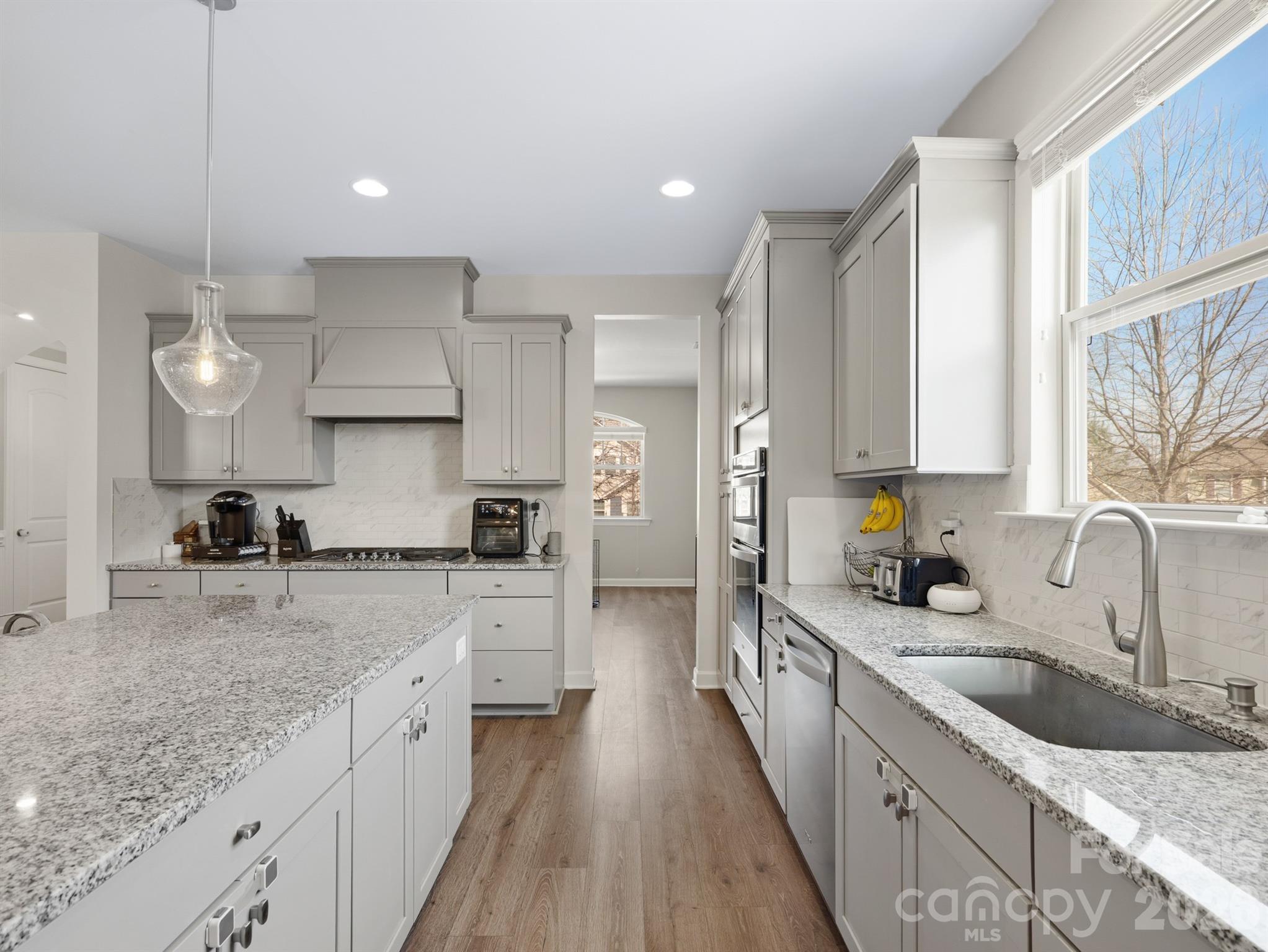 560 Sandbar Point Clover, SC 29710 - Photo 14 of 48 a large kitchen with stainless steel appliances granite countertop a lot of counter space a sink and cabinets