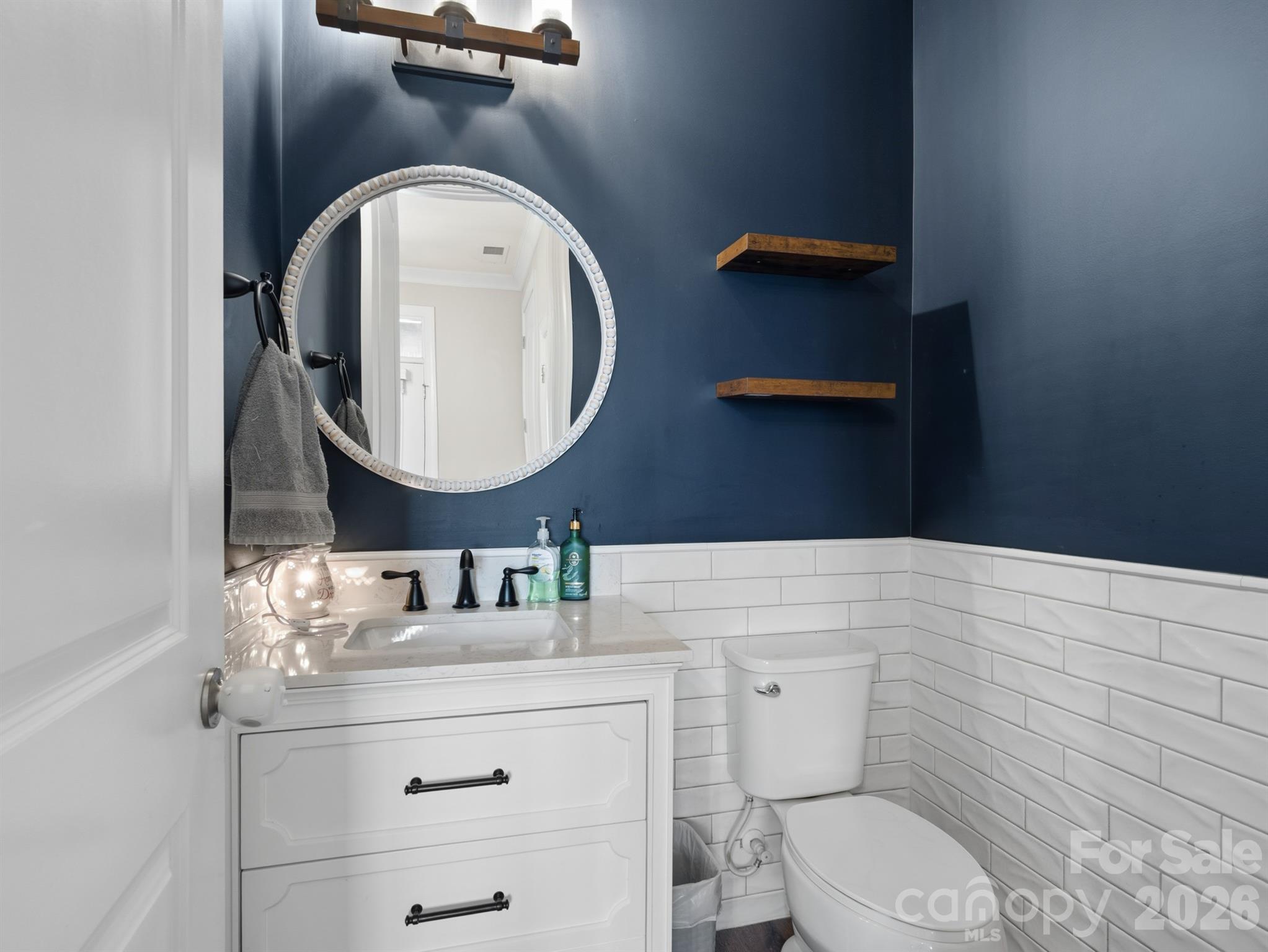 560 Sandbar Point Clover, SC 29710 - Photo 8 of 48 a bathroom with a toilet a sink and mirror