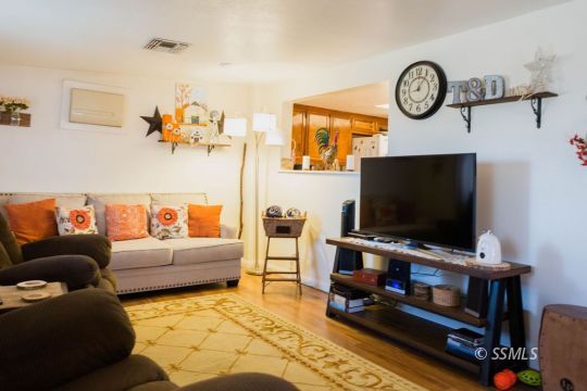 1108 South Allen Street Ridgecrest, CA 93555 - Photo 16 of 34 a living room with furniture and a flat screen tv