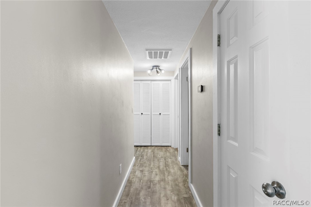 107 Allen Avenue Inglis, FL 34449 - Photo 14 of 36 a view of a hallway with wooden floor