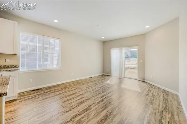 a view of a kitchen with wooden floor