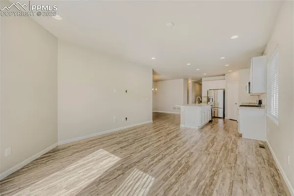 a kitchen with stainless steel appliances granite countertop a refrigerator and a stove top oven