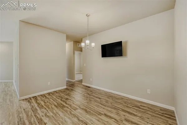 a view of a livingroom with wooden floor and a flat screen tv