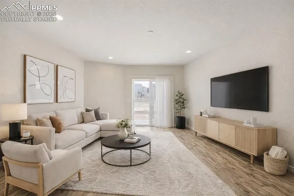 a view of an empty room with wooden floor