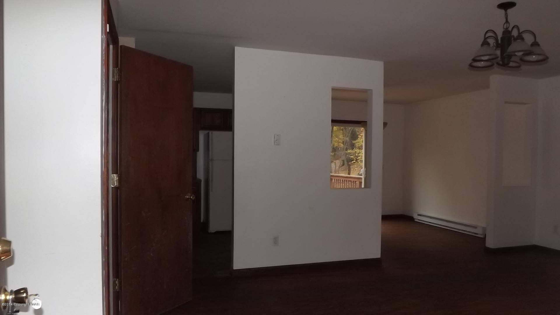 528 Apache Road East Stroudsburg, PA 18302 - Photo 9 of 13 an empty room with wooden floor and cabinet
