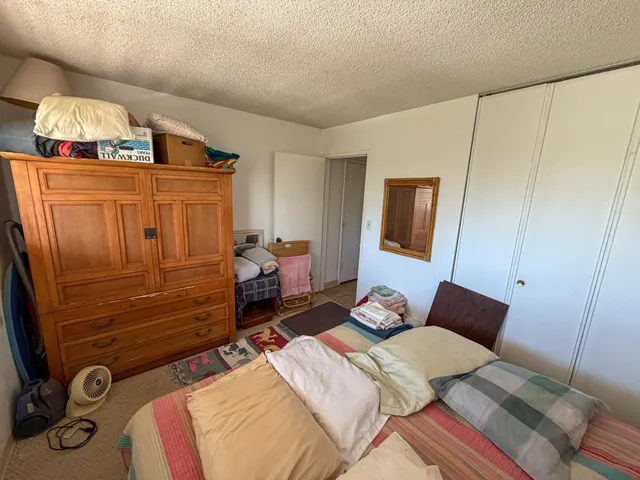 a bedroom with a bed and lamp