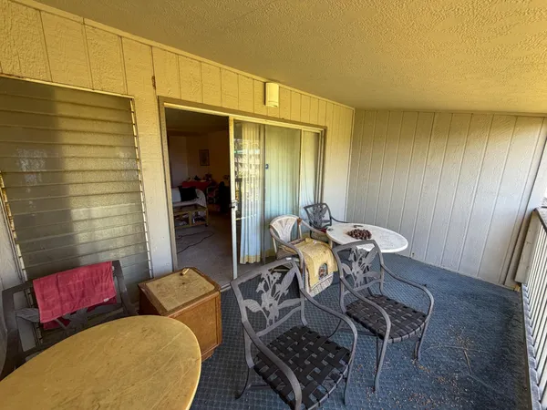 a view of a room with furniture and wooden floor