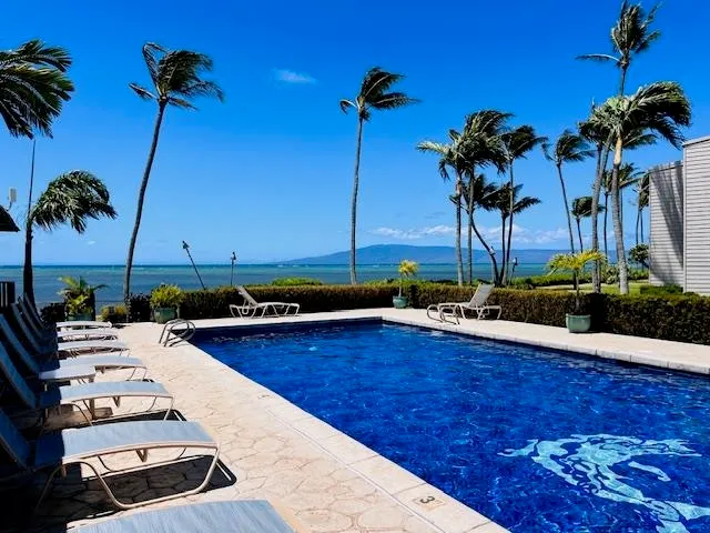 a view of a swimming pool with a table and chairs
