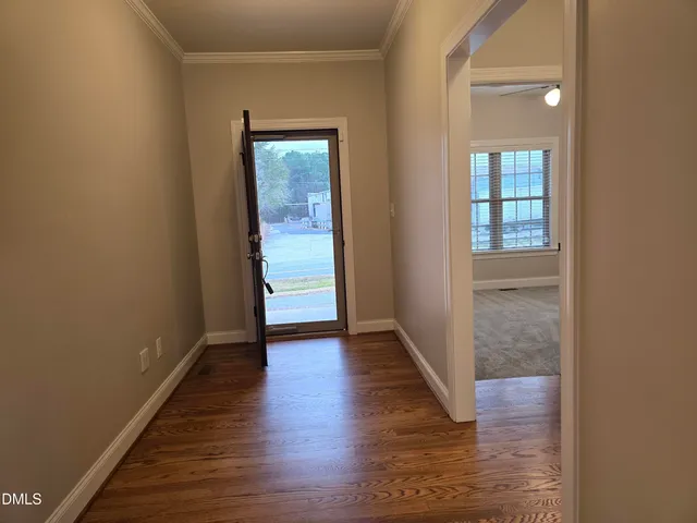 an empty room with a window and a ceiling fan