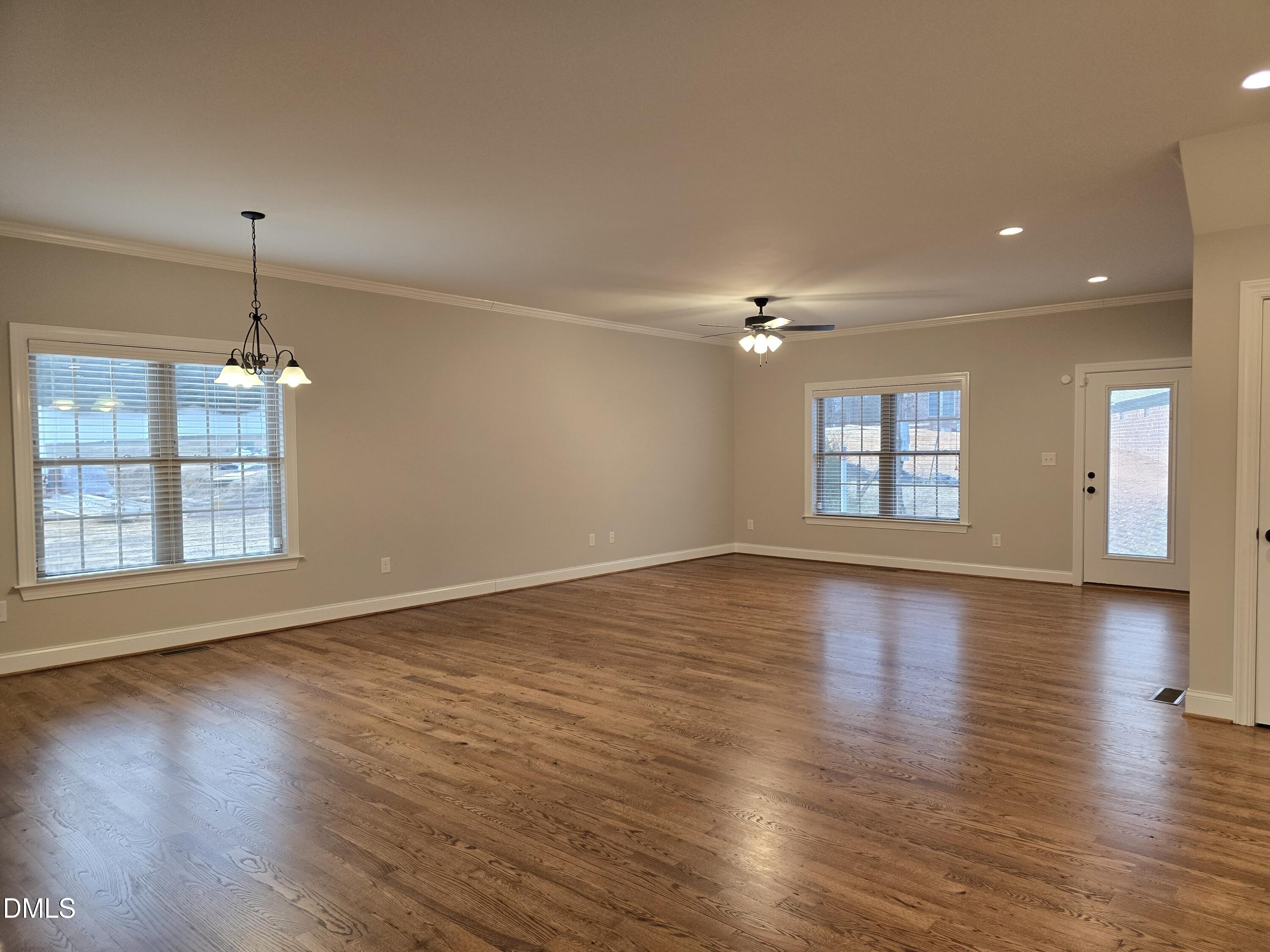 933 Arrowhead Court Mebane, NC 27302 - Photo 28 of 84 an empty room with wooden floor and windows