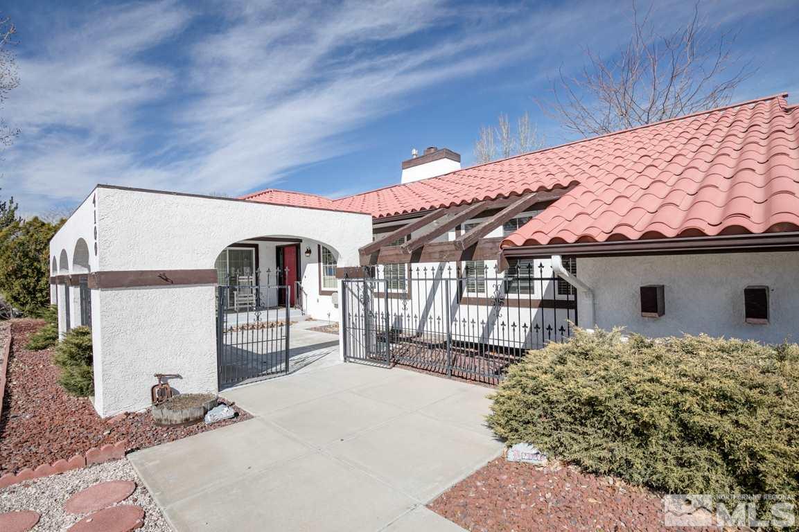 4100 Magnolia Road Fallon, NV 89406 - Photo 4 of 25 a backyard of a house with large trees and plants