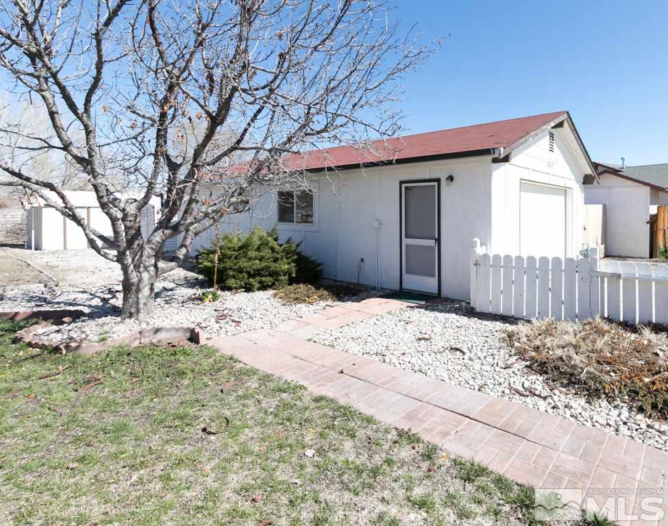 4100 Magnolia Road Fallon, NV 89406 - Photo 5 of 25 a front view of a house with a yard covered in snow