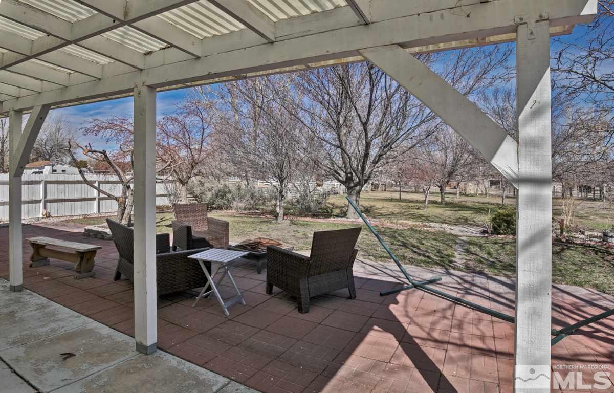 4100 Magnolia Road Fallon, NV 89406 - Photo 8 of 25 a view of a patio with table and chairs and couches with wooden floor and fence
