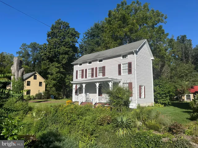 a view of a house with yard and sitting area