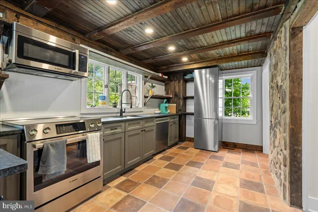 a kitchen with a stove sink and microwave