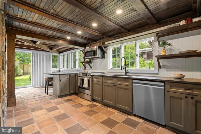 a kitchen with a sink window and cabinets