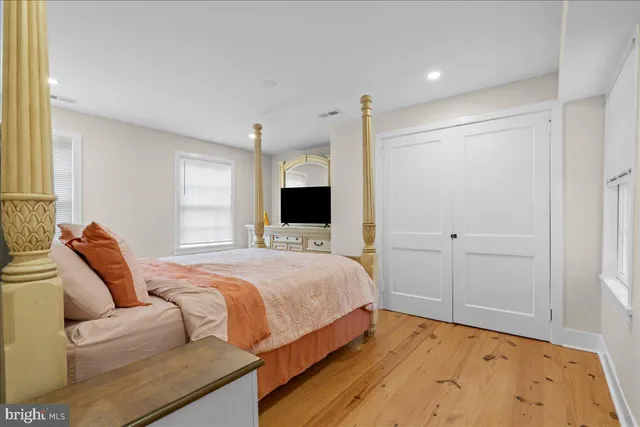 a bedroom with a large bed and a flat screen tv