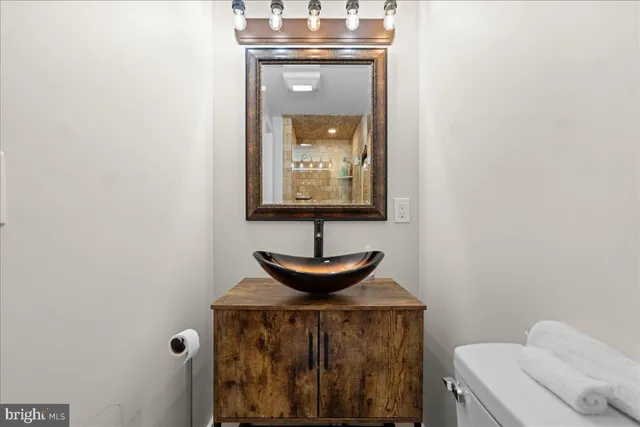 a view of a hallway with a stove and a sink