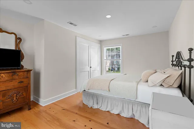 a bedroom with a bed and flat screen tv