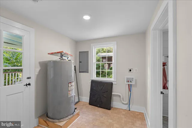 a living room with stainless steel appliances granite countertop furniture and a window