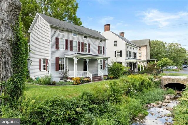 a front view of a house with garden and porch