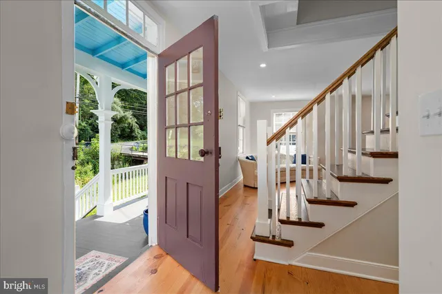 a view of entryway and hall with wooden floor