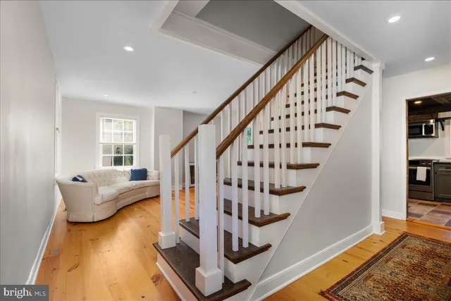 a view of entryway and hall with wooden floor