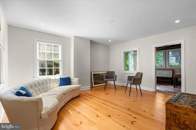 a living room with furniture a dining table and a window