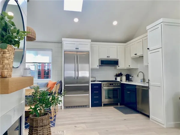 a kitchen with stainless steel appliances a refrigerator sink and cabinets